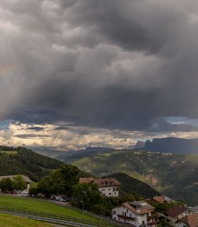 Nuvole e un arcobaleno sopra San Genesio